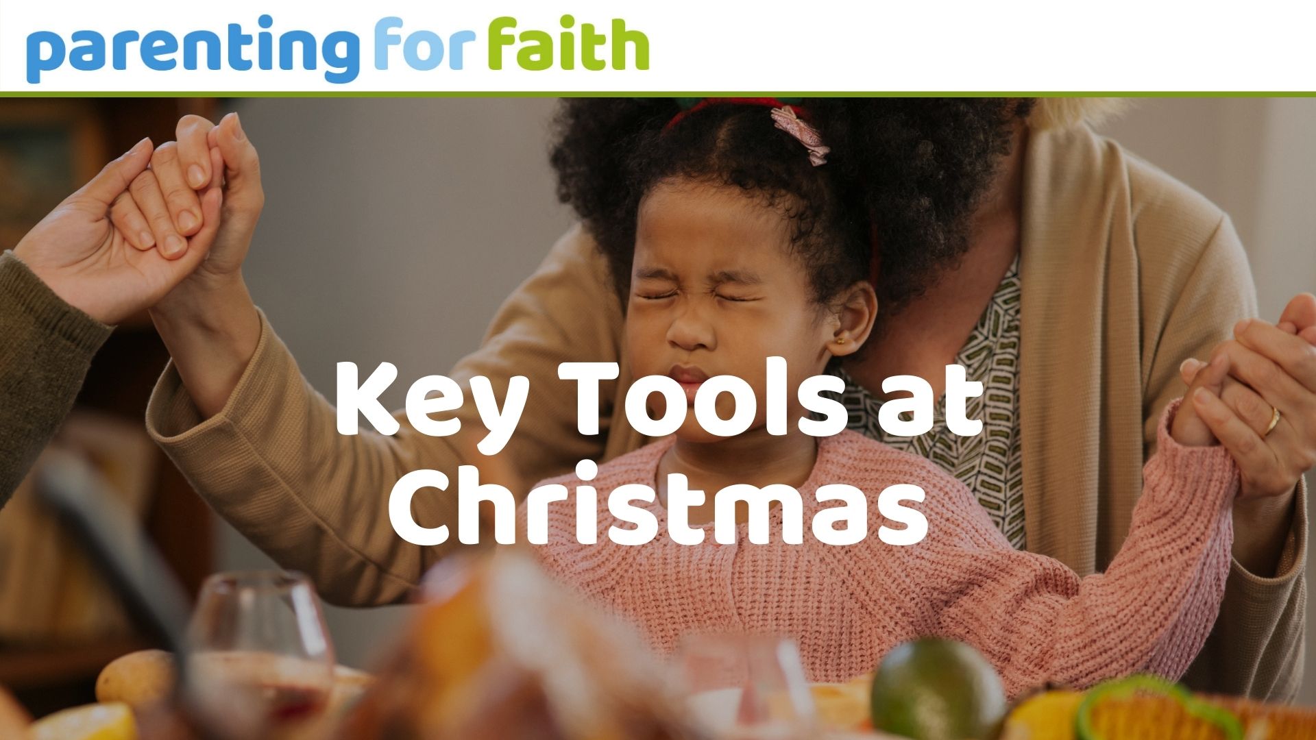 Girl praying with her family before Christmas dinner.