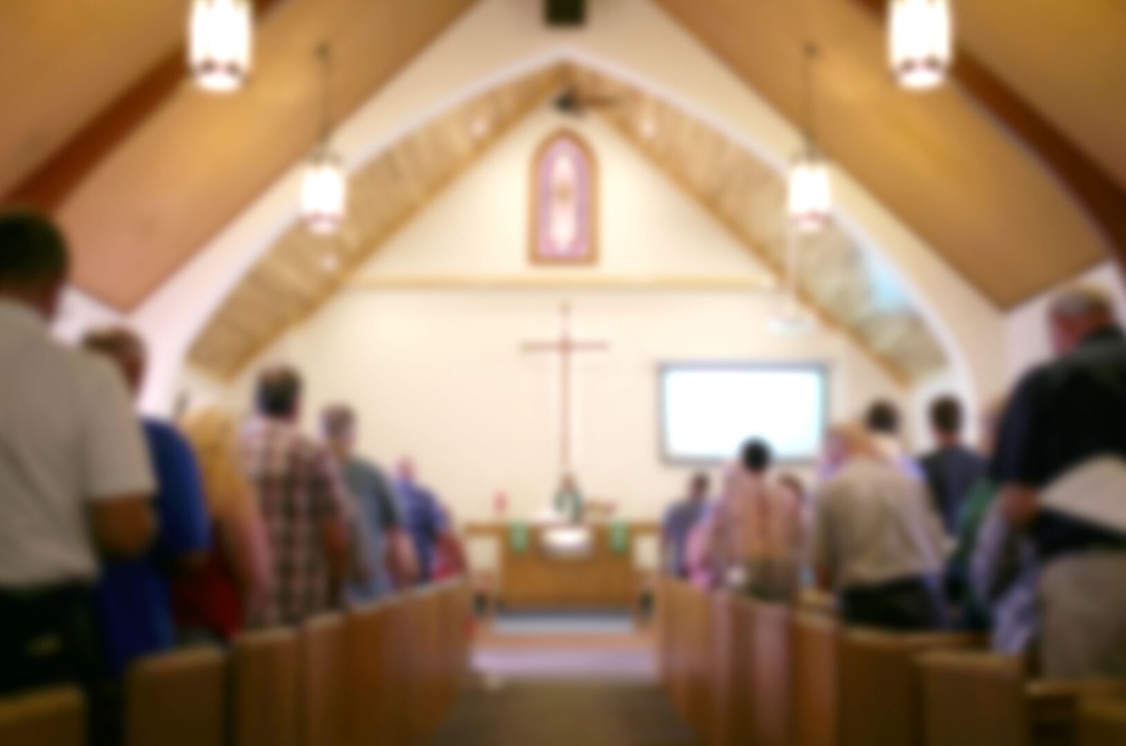 A blurred photo of the inside of a church sanctuary